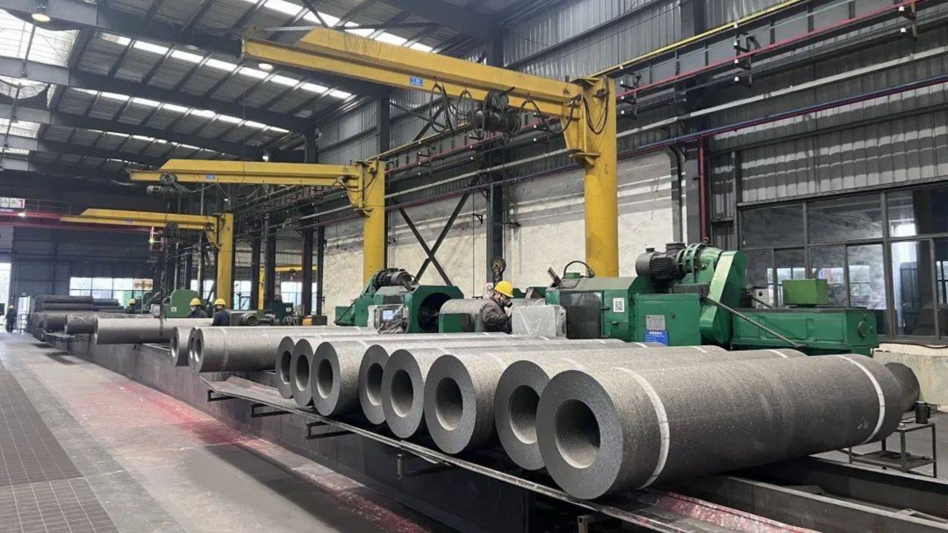 Modern graphite electrode and carbon product factory with advanced production equipment for steelmaking and metallurgy industries.